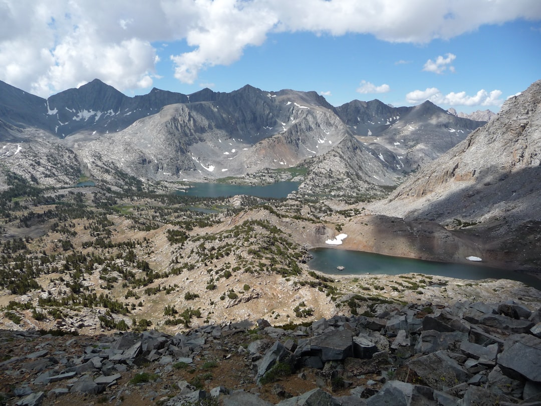 hiker wearing backpack looking at mountain