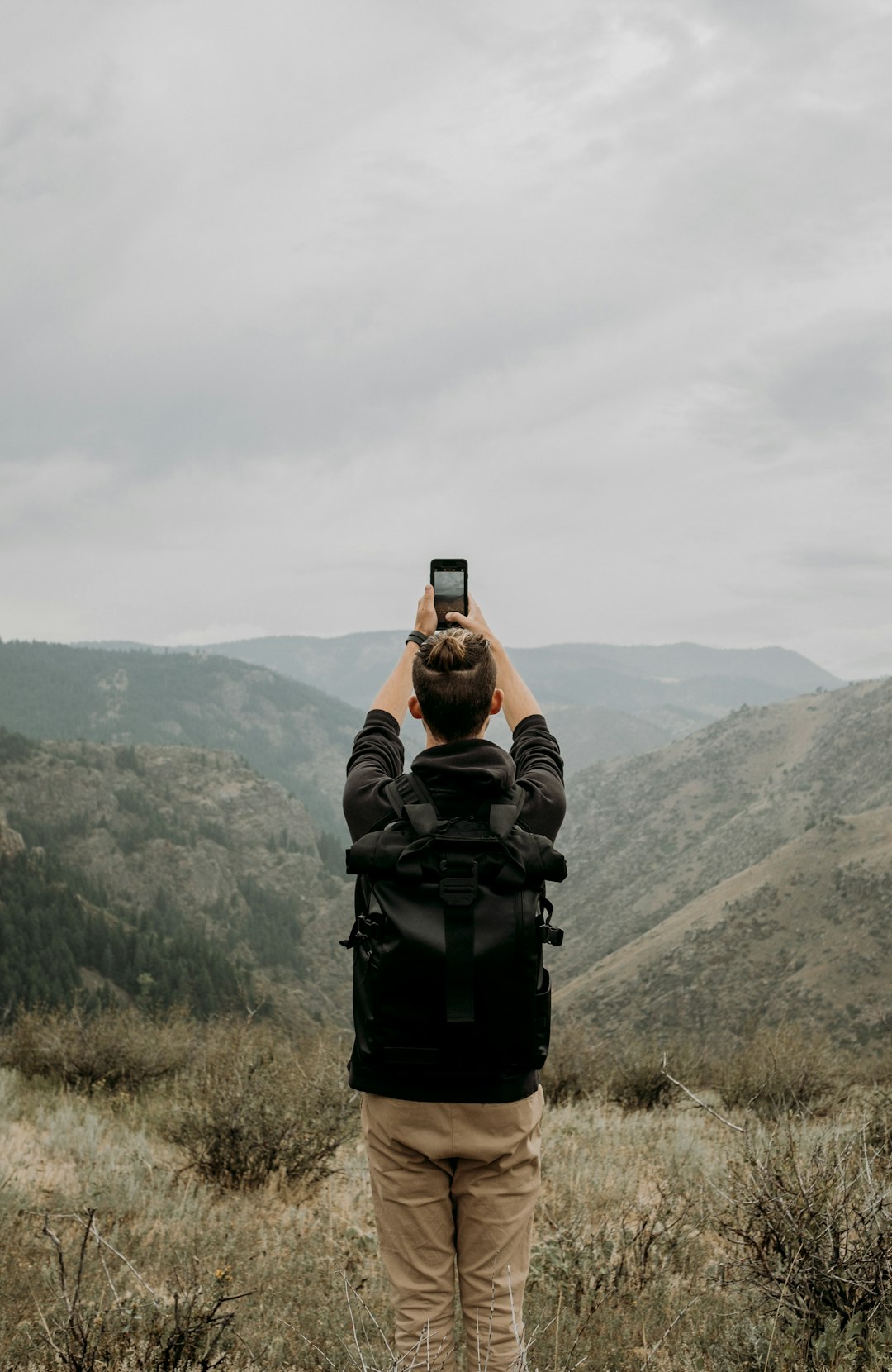 man standing and capturing hills