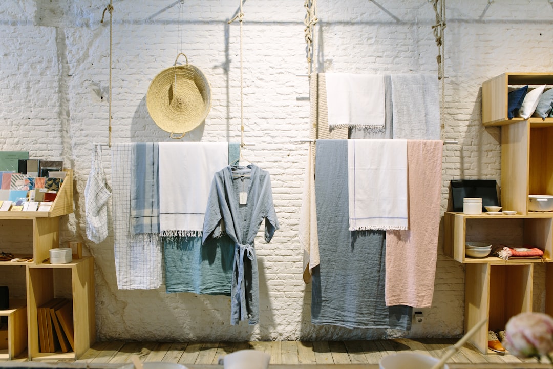 Towels and clothes on lines by Backpack Brands assorted-color towels hanging inside room