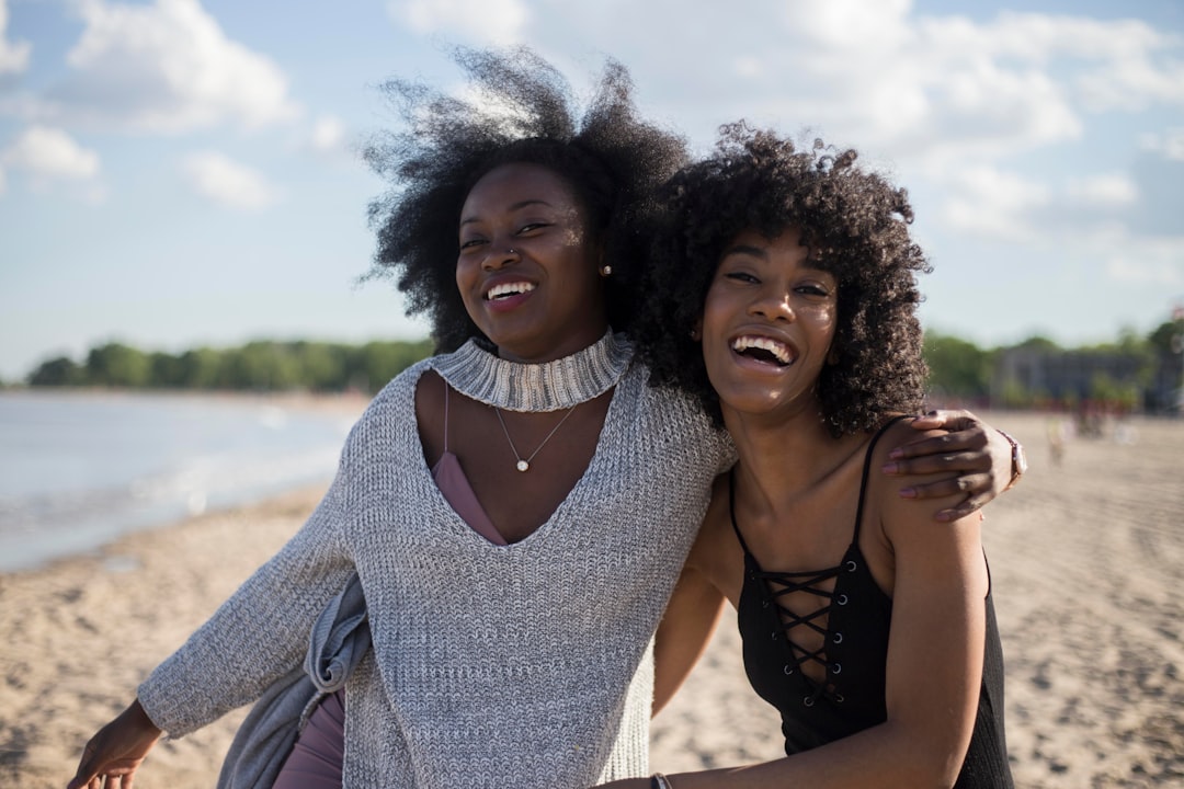 Best friends in summer on the beach girls by Backpack Brands photo of woman beside another woman at seashore
