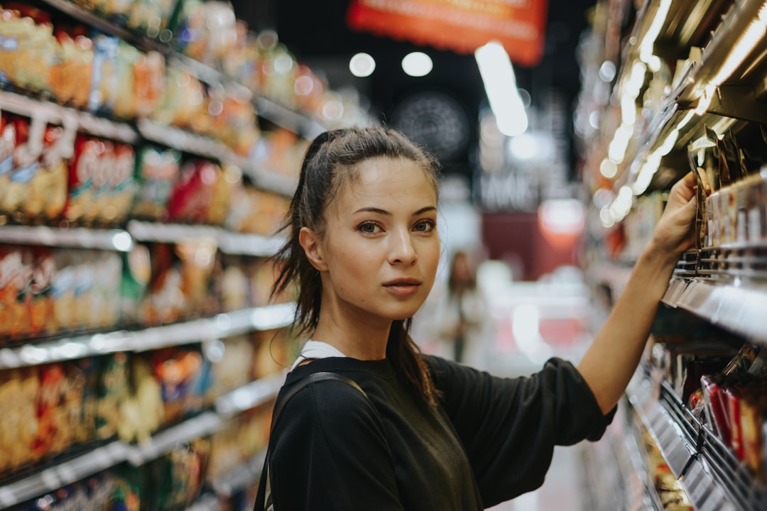 Picture taken for CouponSnake – https://couponsnake.com/ by Backpack Brands woman selecting packed food on gondola