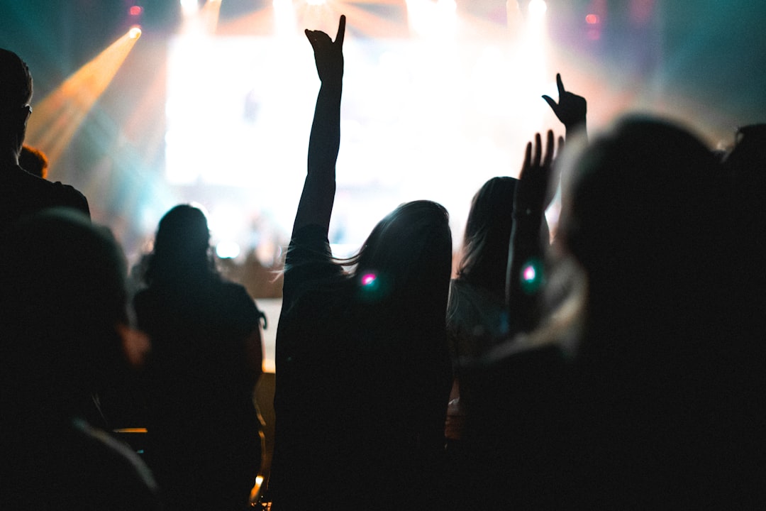 Worship night at Eastside Christian Church in Anaheim, California. It is always amazing to see the production and lighting that Eastside uses to capture audiences. by Backpack Brands group of people standing in front of concert