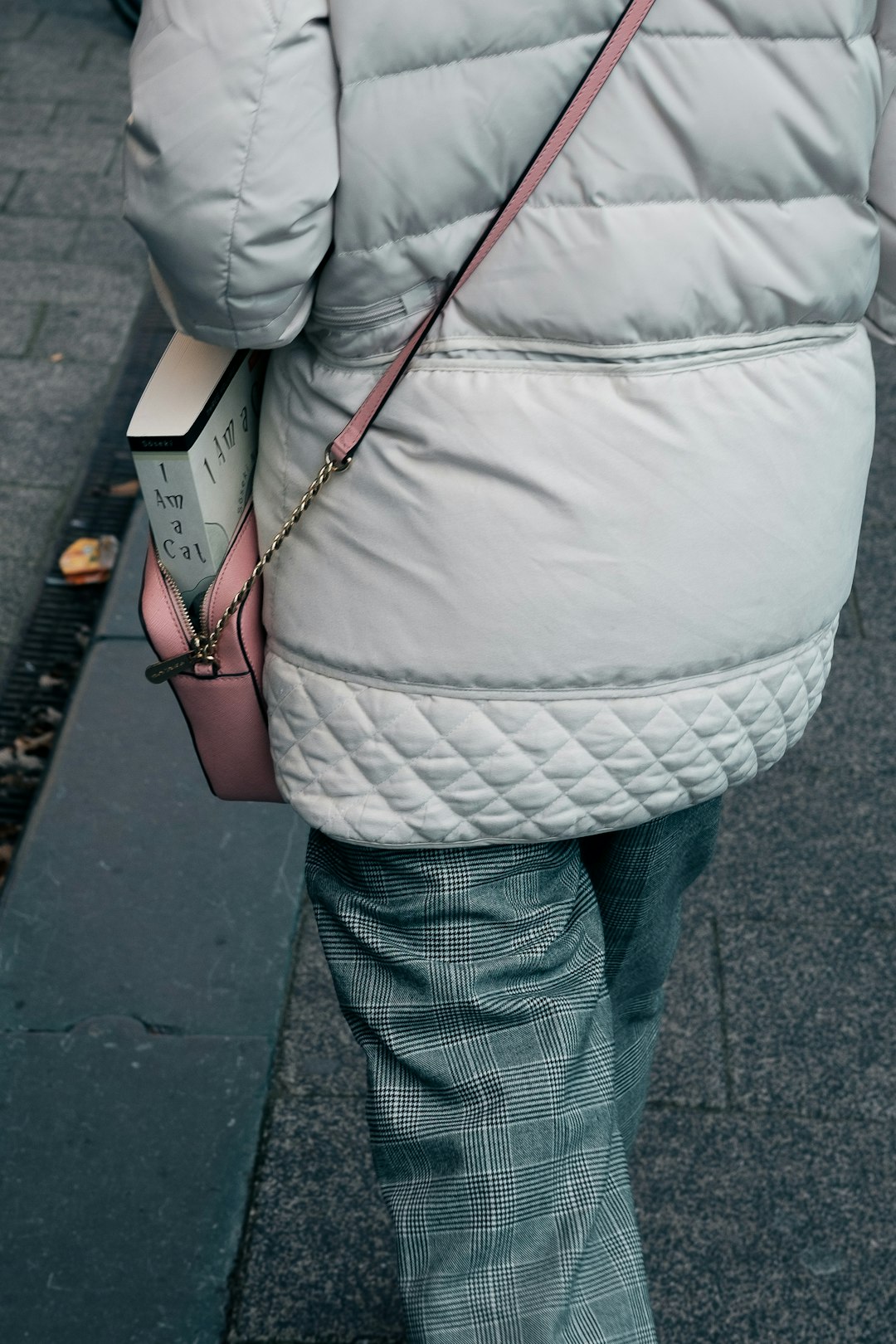 person walking on gray pavement