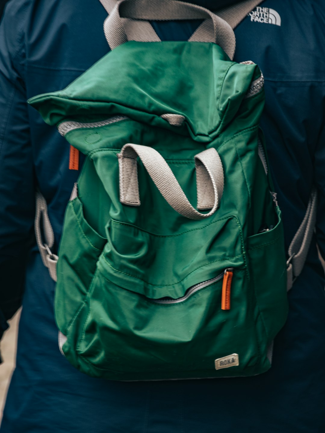 a person with a green backpack on their back