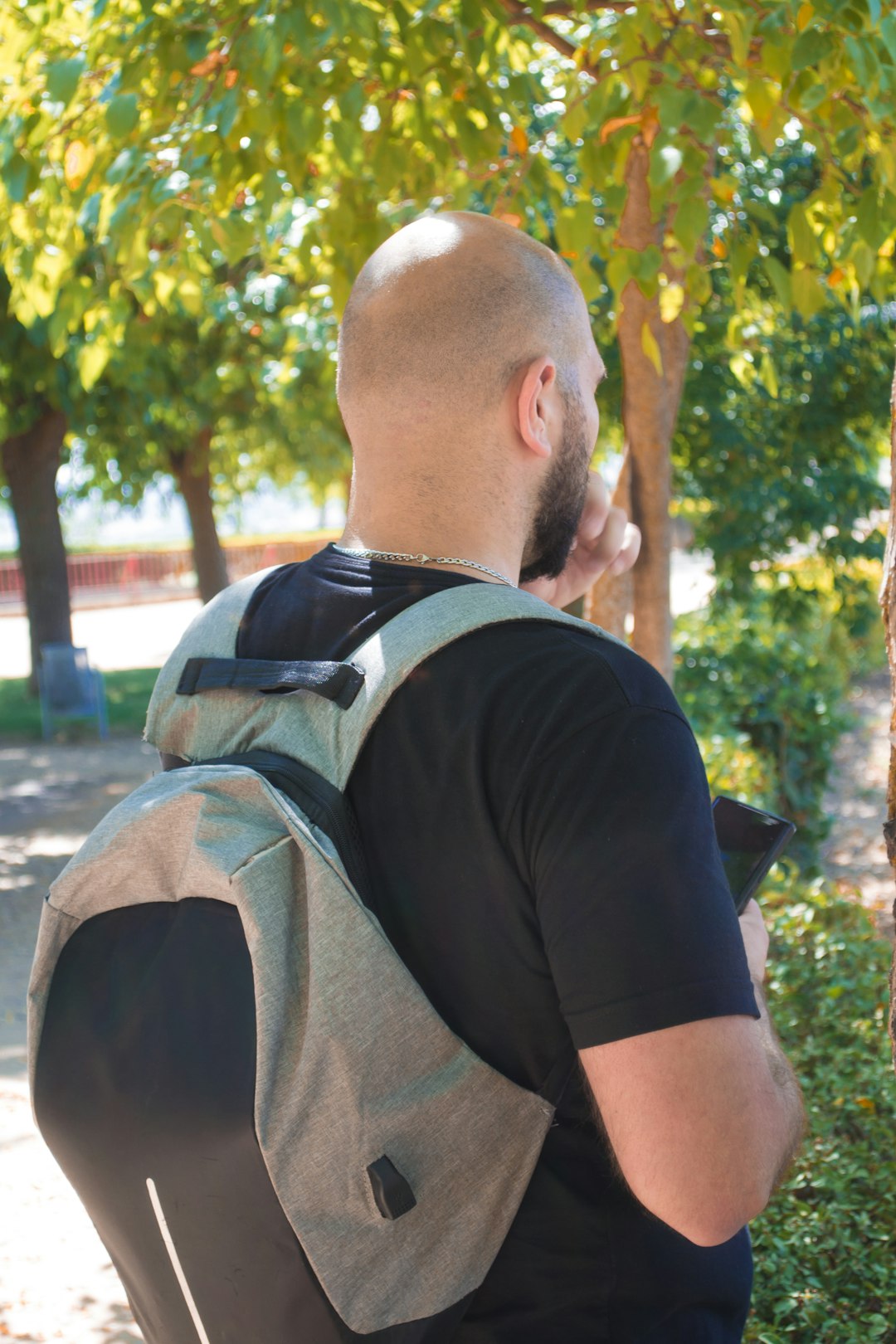 a man sitting on a bench with a backpack on his back