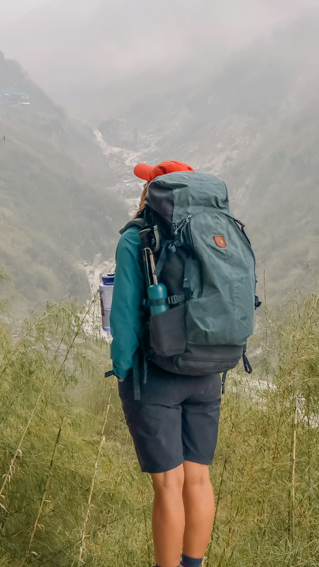 a person with a backpack walking up a hill